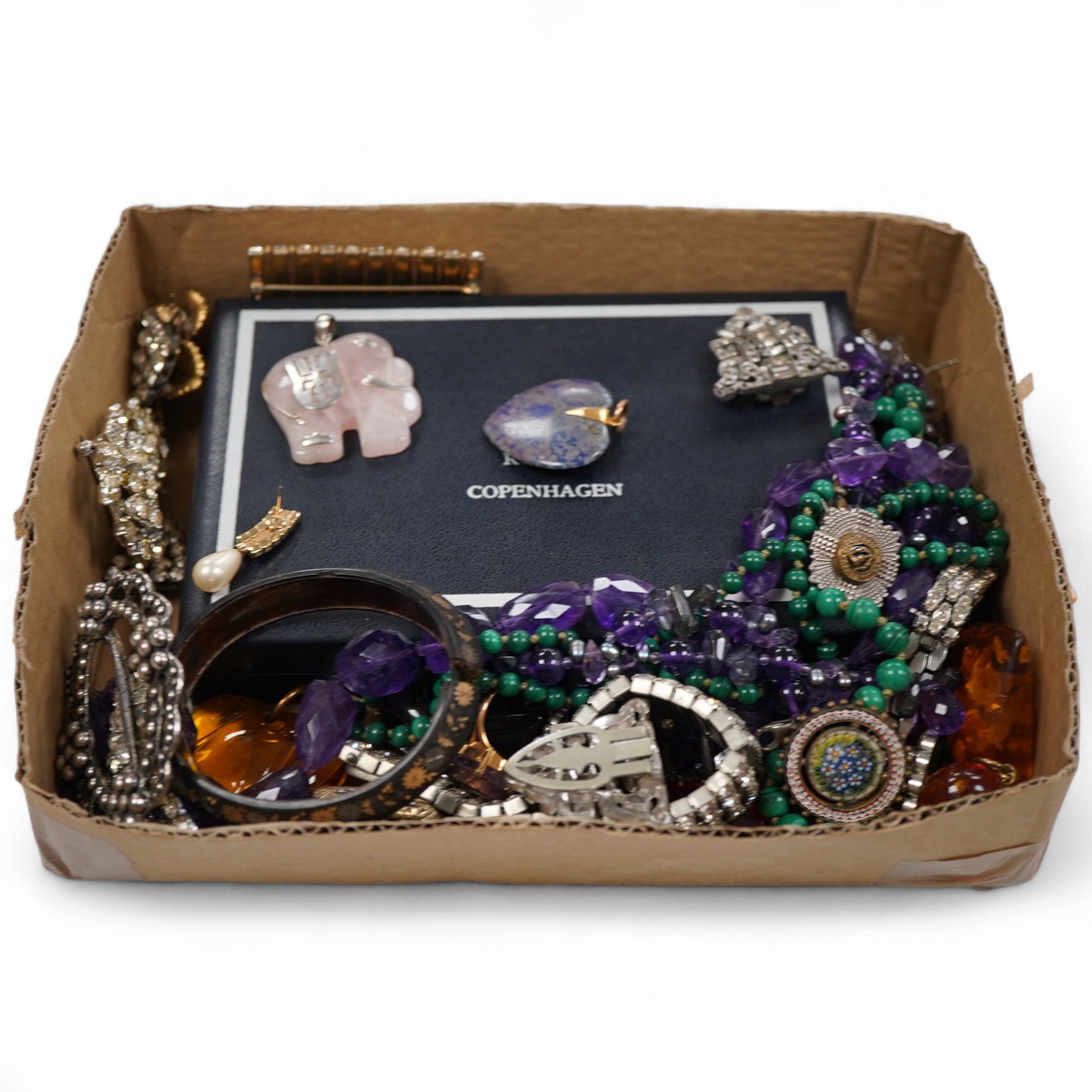 A collection of costume jewellery to include a yellow metal and amethyst ring, two George V silver and guilloche enamel brooches, two amethyst necklaces, etc